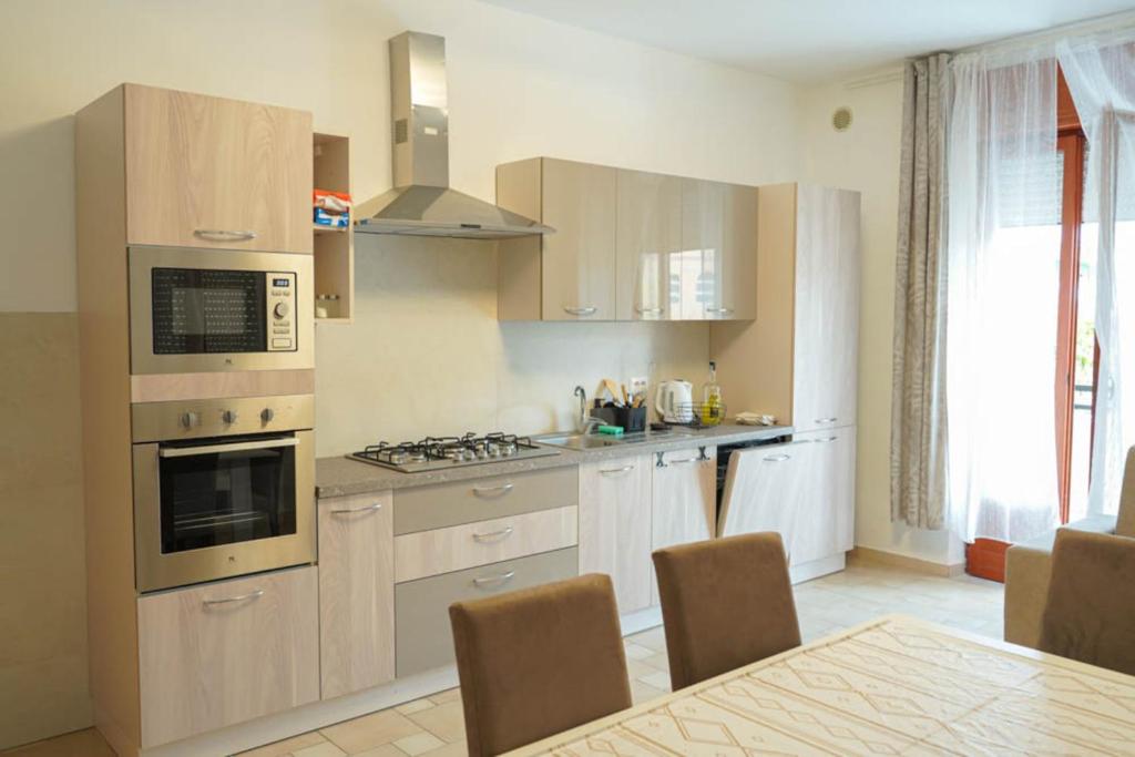 a kitchen with white cabinets and a stove top oven at Casa Solemare Strongoli in Marina di Strongoli