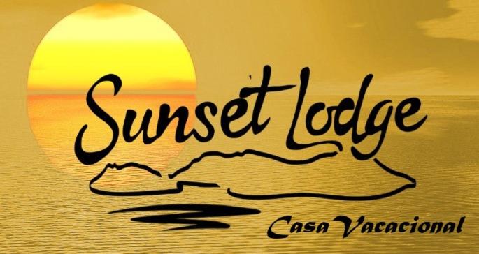 a sunset picture with the words sunset idle in front of the ocean at sunset lodge in Las Manchas