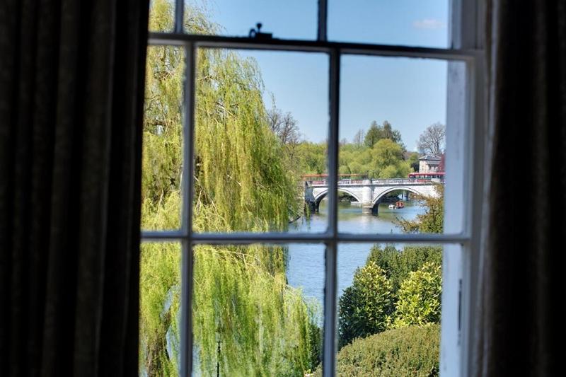 a window with a view of a bridge over a river at Bingham Riverhouse in Richmond upon Thames