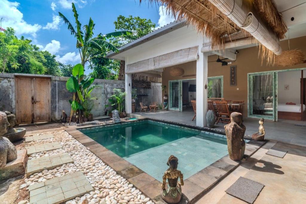a villa with a swimming pool and a house at Jellyfish2 2BR for Groups, 5 Min to Thomas Beach in Uluwatu