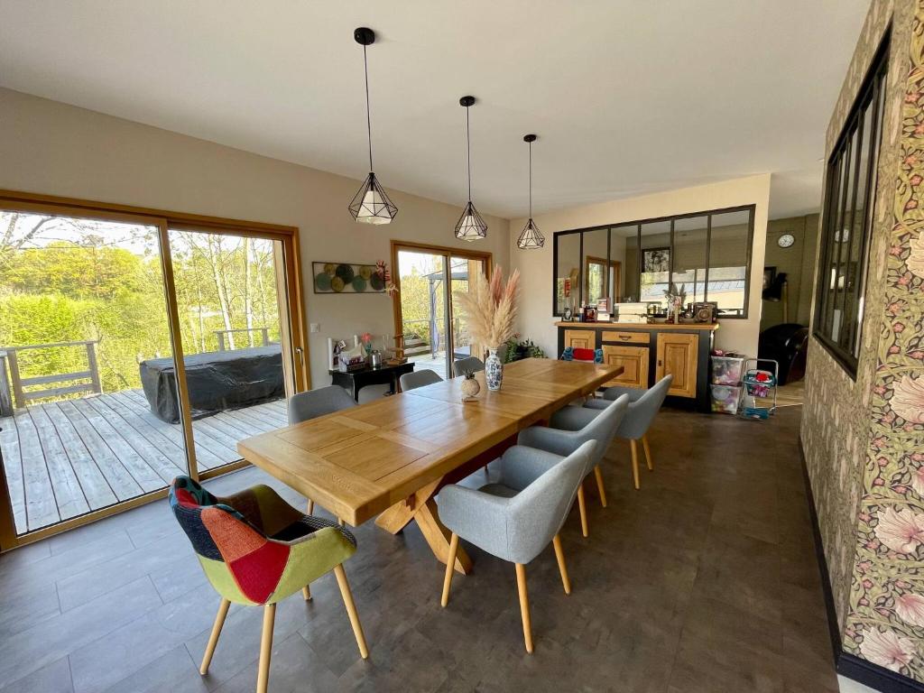 a dining room with a wooden table and chairs at Tardif in Vitré