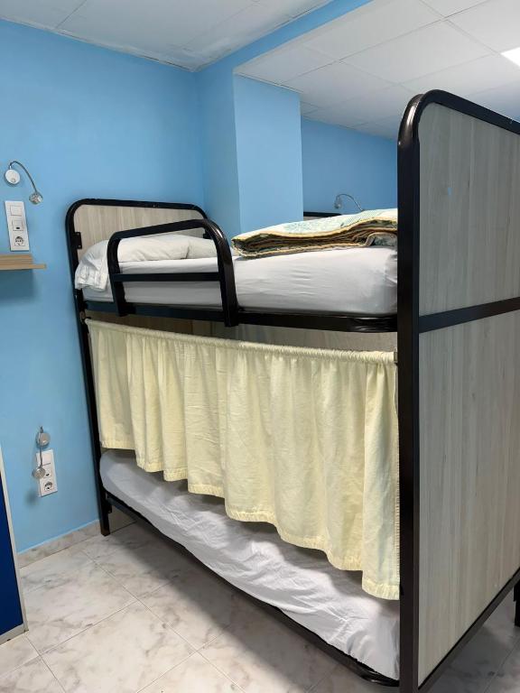 a couple of bunk beds in a room at km24 ALBERGUE in Padrón