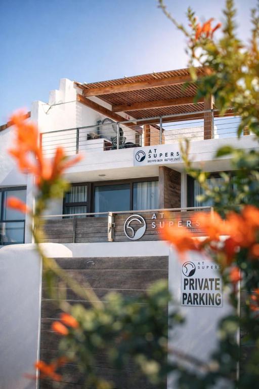a building with a sign that reads private parking at AtSupers Accommodation in Jeffreys Bay