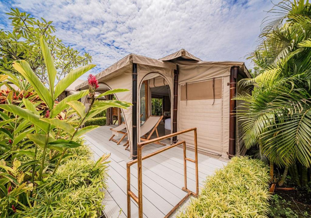 a house with a gazebo in a garden at Bali Beach Glamping in Tabanan