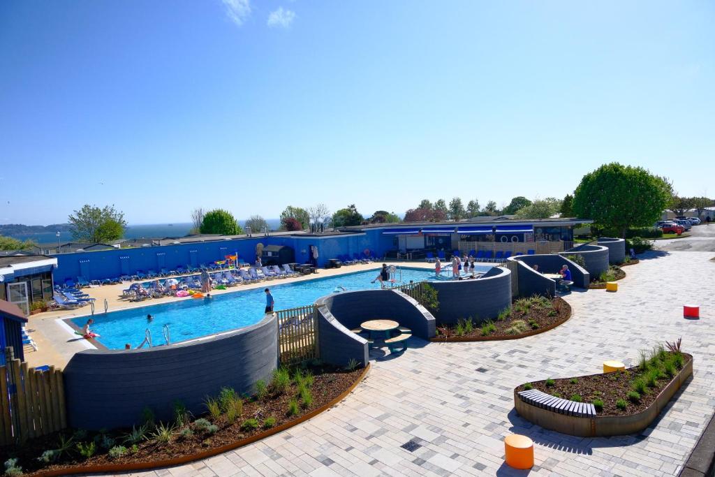 a pool at a resort with people in it at Beverley Park in Goodrington