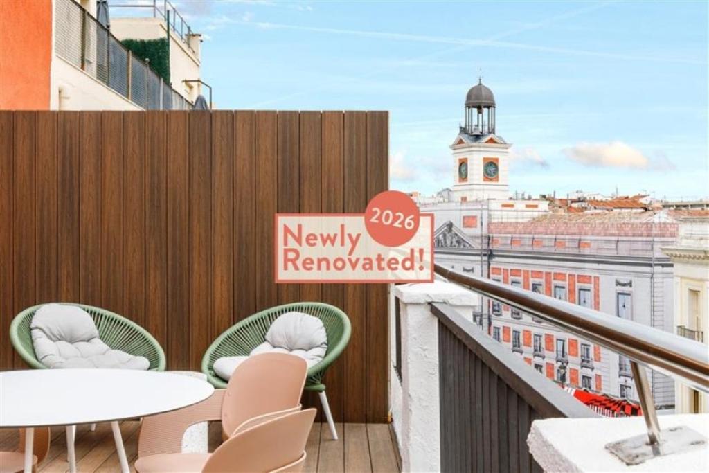 a balcony with tables and chairs and a sign that reads newly renovated at Petit Palace Puerta del Sol in Madrid