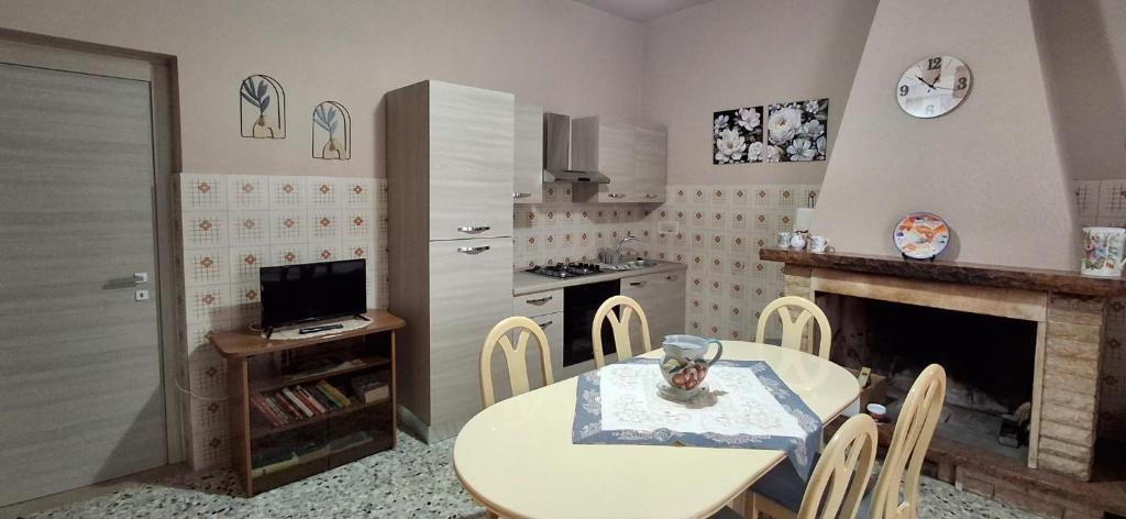 a kitchen with a table and a table and a fireplace at Stella Bianca in Giulianova