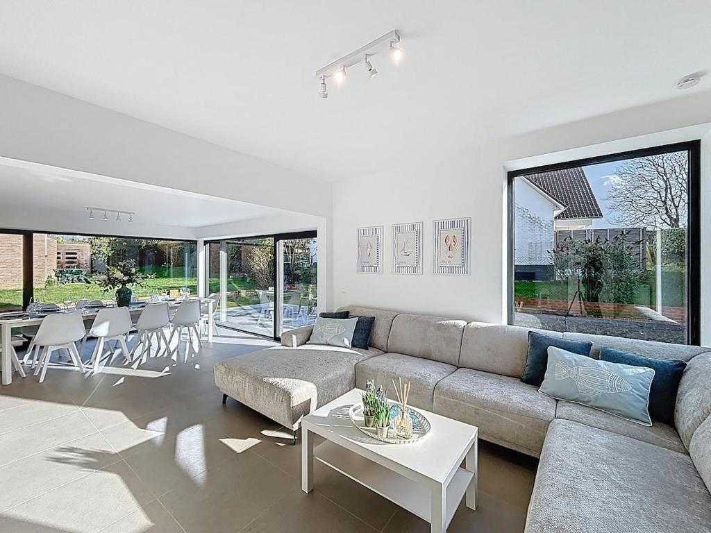 a living room with a couch and a table at Villa Pomone - Sint-Idesbald in Koksijde