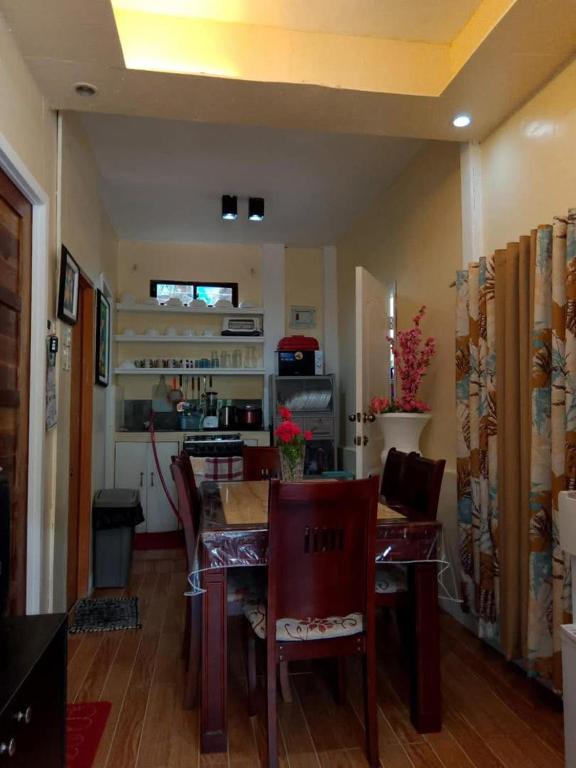 a kitchen with a table and chairs in a room at Laguerta Tahas House in Cebu City