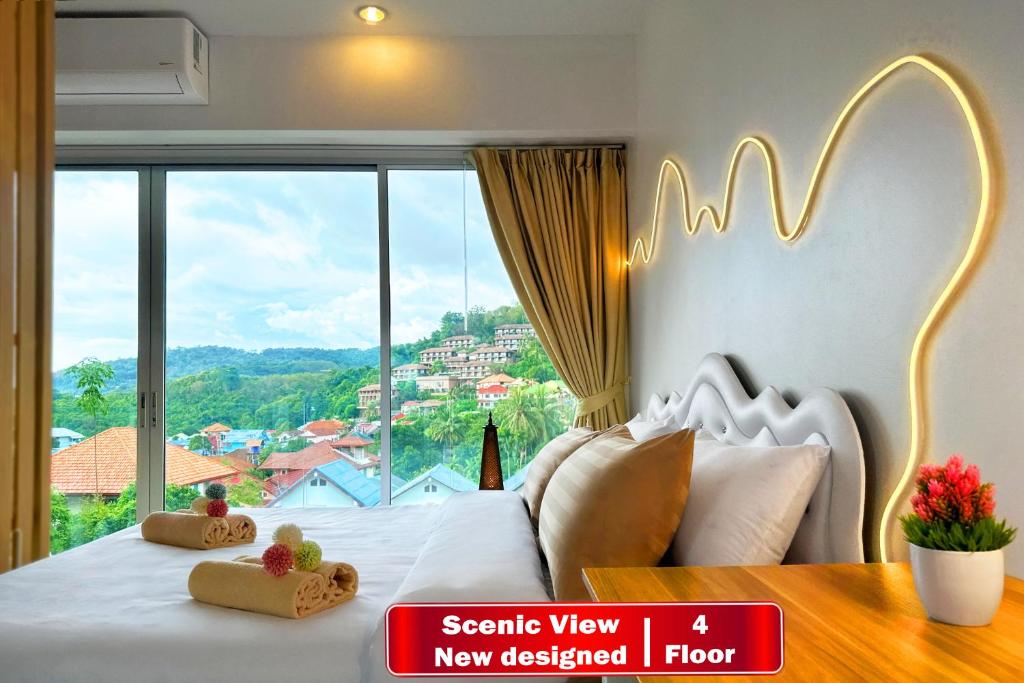a bedroom with a white bed with a large window at Scenic Condo 50 sqm Karon in Karon Beach