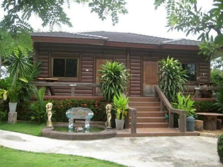 a log cabin with a fountain in front of it at Mireya Resort Khaoyai in Ban Khanong Phra Nua