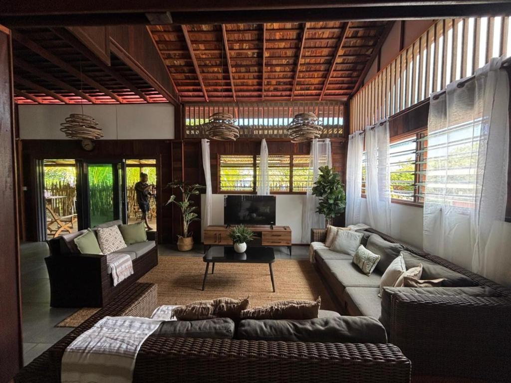 a living room with a couch and a tv at KAZ DIBWA Beach House in Glacis