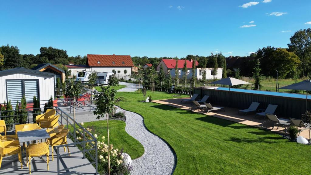 an image of a garden with yellow chairs and a pathway at Bear Camp Kamionna in Kamionna