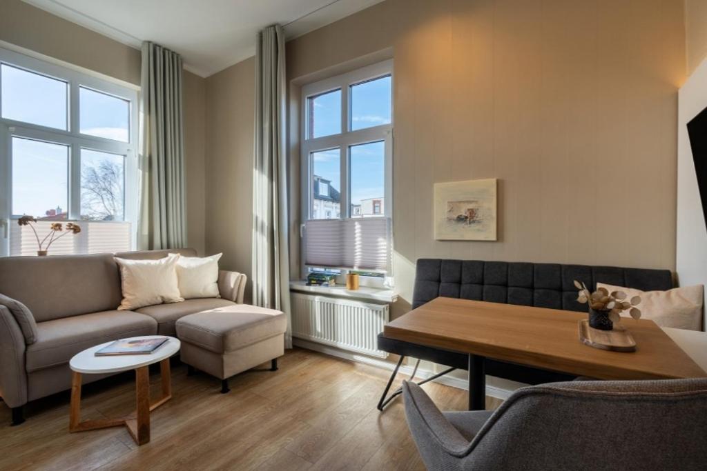 a living room with a couch and a table at Woge2 Appartement 7 in Borkum
