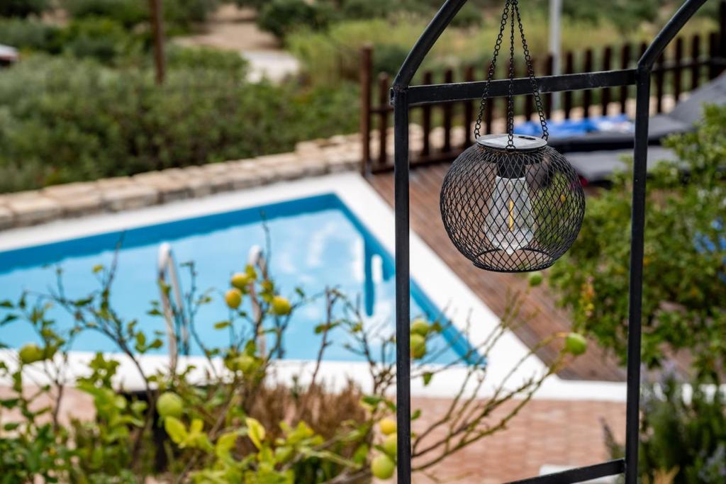 a basket is hanging next to a swimming pool at The Retreat in Ierapetra