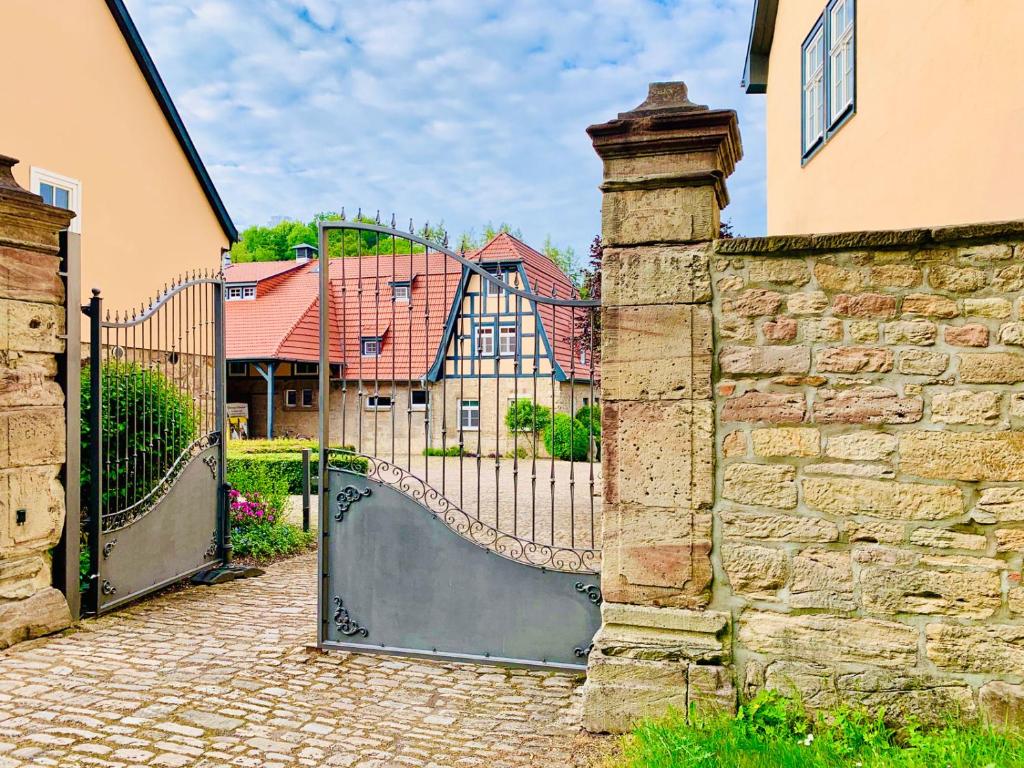 a gate to a house with a stone wall at Sophienhof in Bad Berka