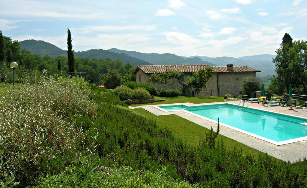 a swimming pool in a yard with a house at Villa Santa Maria a Bovino in Vicchio