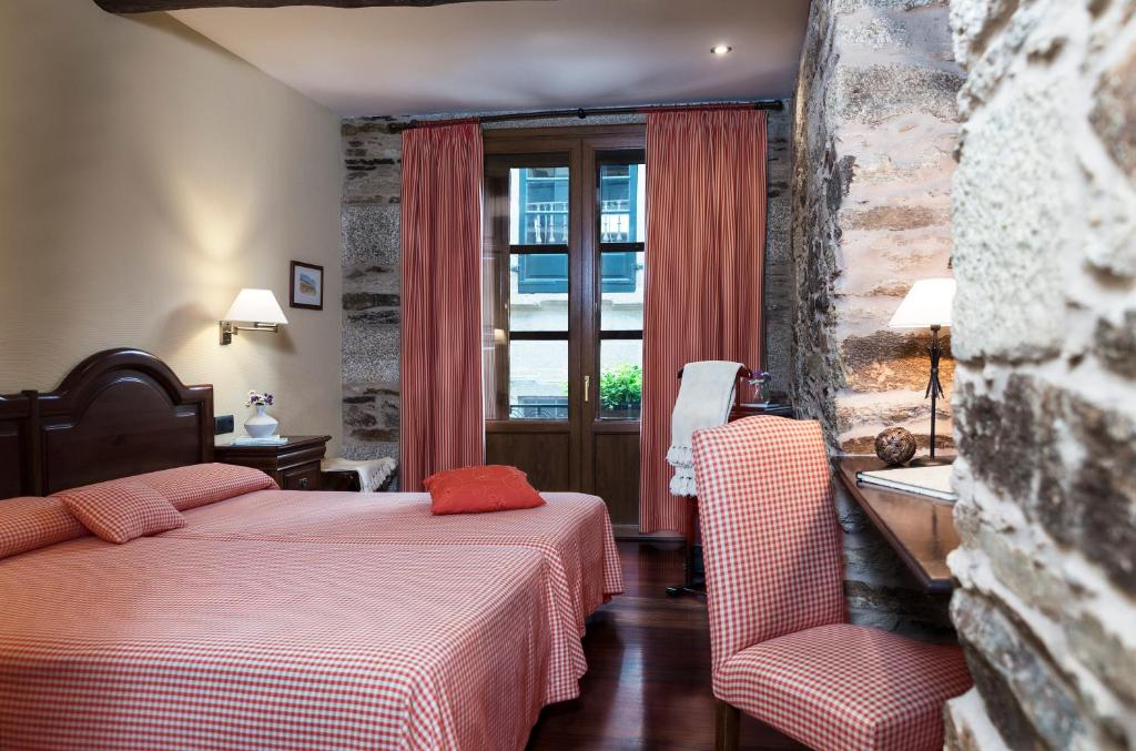 Habitación de hotel con 2 camas y ventana en Hotel Rua Villar, en Santiago de Compostela
