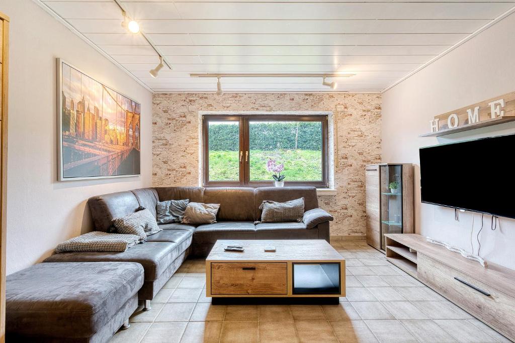 a living room with a couch and a flat screen tv at Am Linnert in Haltern