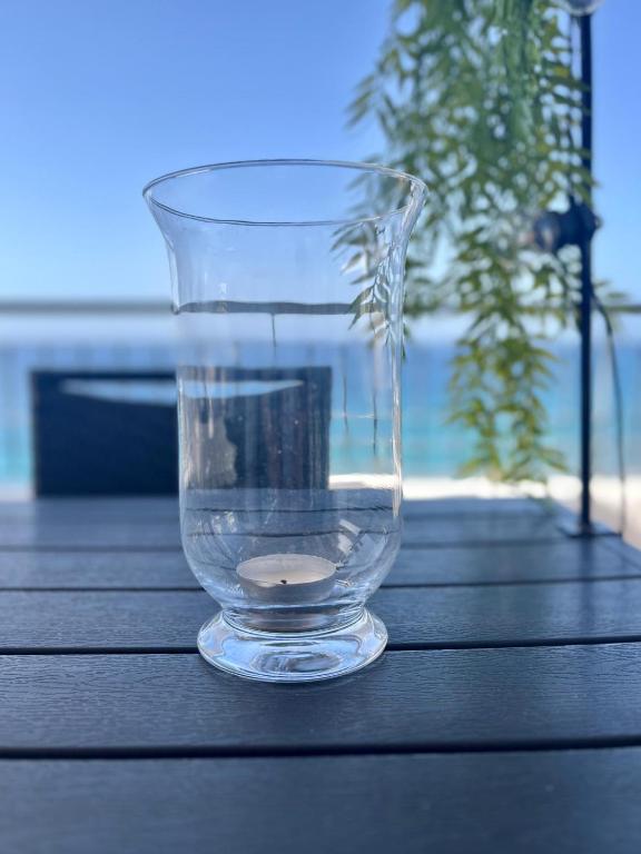 a glass vase sitting on top of a wooden table at Best Vistamar Sea View in Torrox Costa