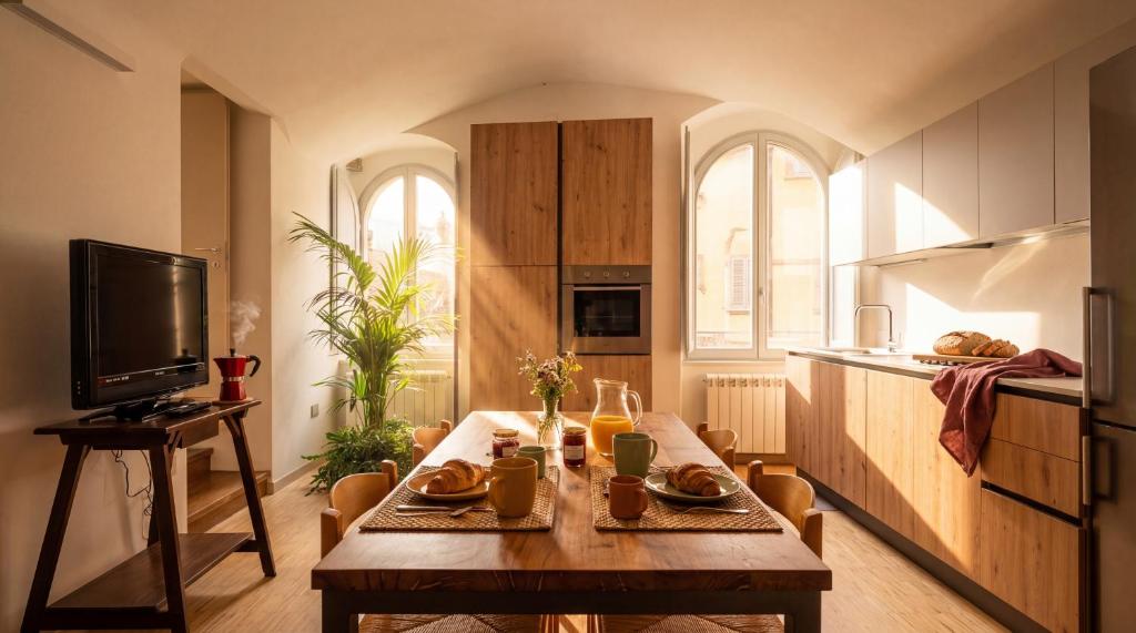 a kitchen with a wooden table in a room at Edoardo Historic House in Gubbio