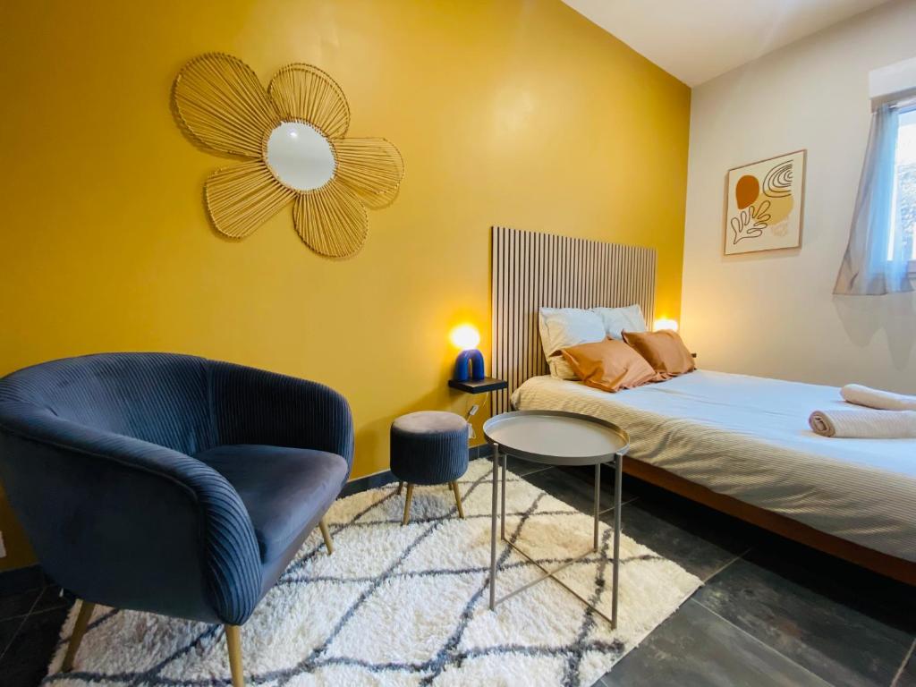 a small bedroom with a bed and a chair at Le Petit Francillon in Villebarou