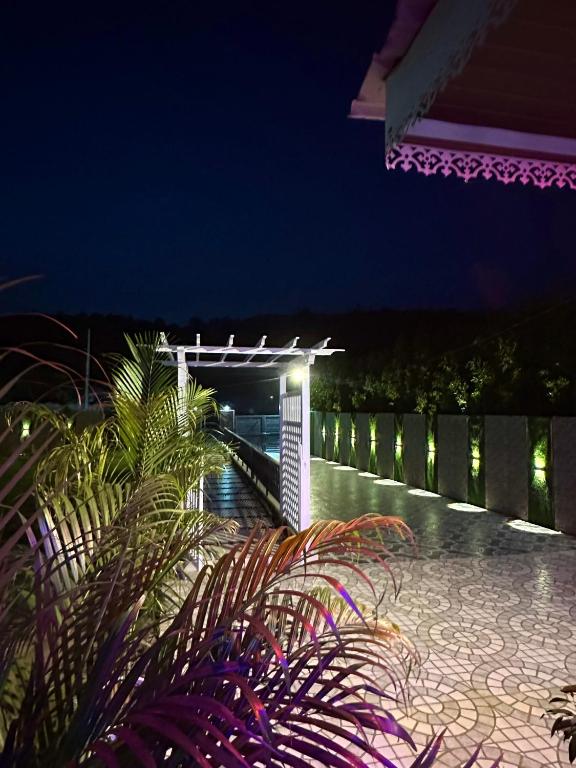 a night view of a patio with a fence at Nagpal Farm in Panchkula
