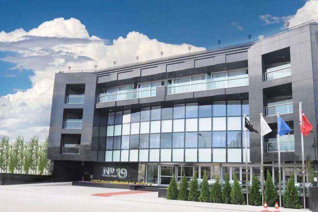 a large office building with flags in front of it at No 19 Boutique Hotel in Ankara