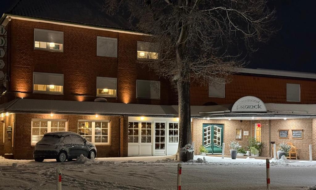 a building with a car parked in front of it at Landhotel Franck Garni in Brietlingen