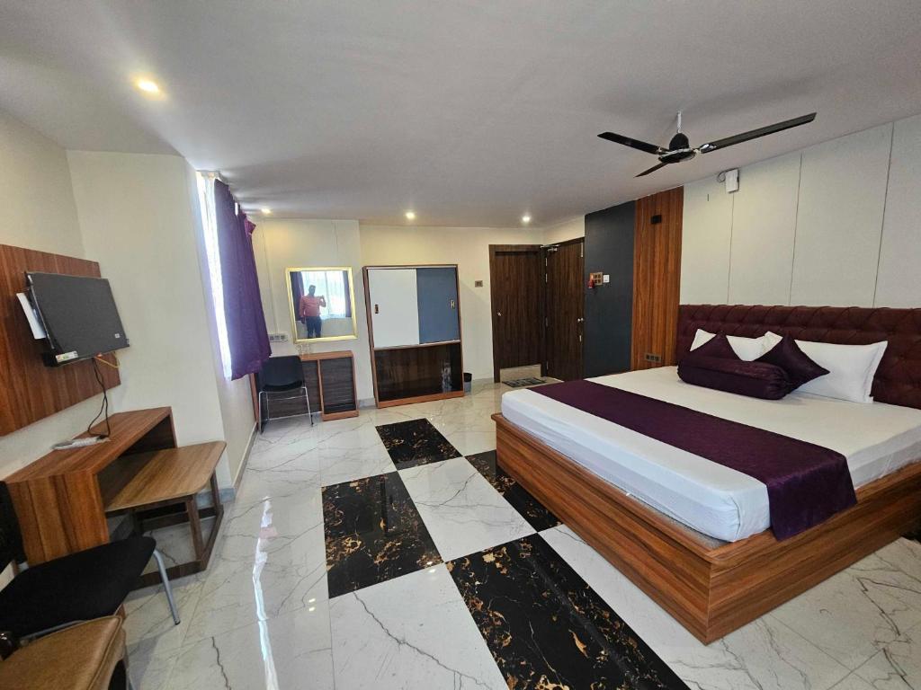 a bedroom with a bed and a television in it at Hotel O D S in Rāmgarh