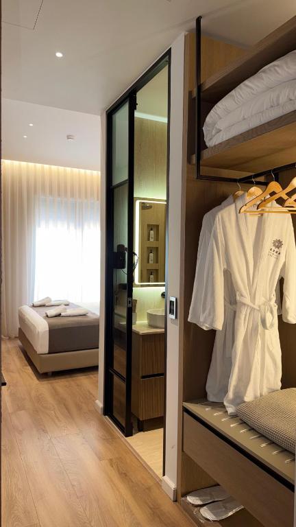 a room with a bedroom with a bed and a mirror at Terra Boutique Hotel in Tirana
