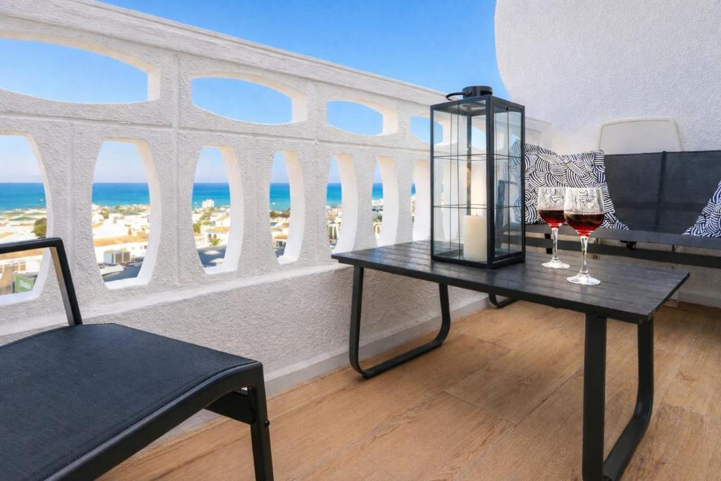 a room with two glasses of wine and a window at Amber Signature Apartment in Torrevieja