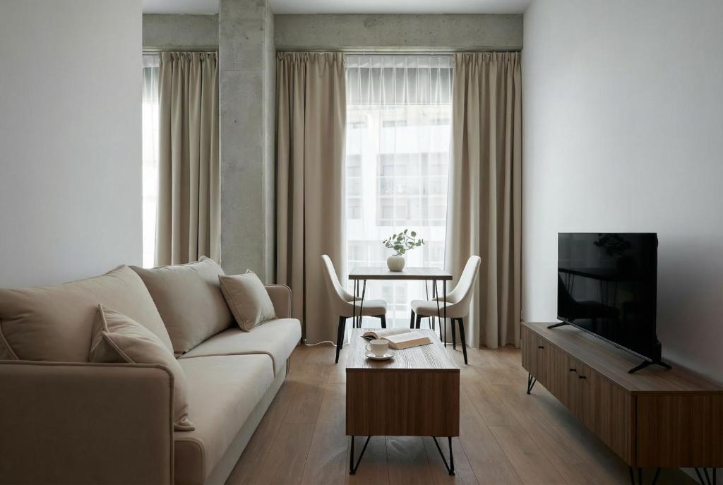 a living room with a couch and a table at Aparthotel Symphony Krakowska 35 by INA in Wrocław