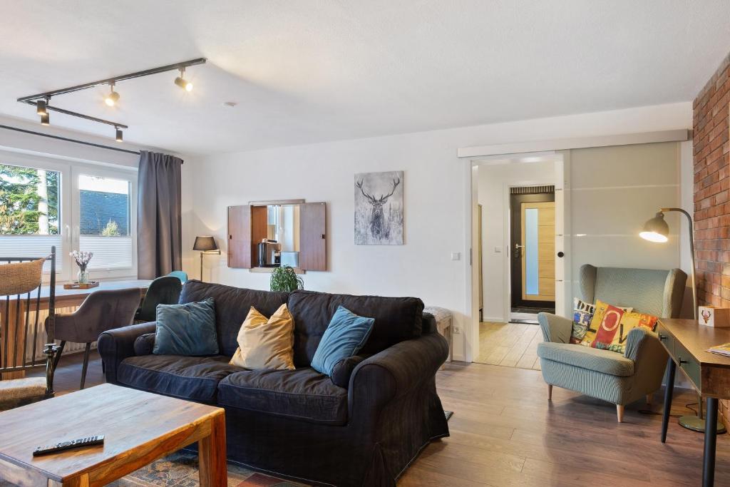 a living room with a couch and a table at Panoramablick und Ruhe in Titisee-Neustadt