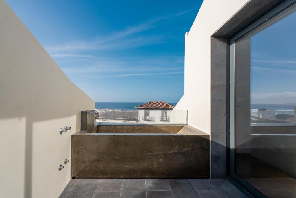 a view from the balcony of a house at Essence Villas - Bath & Sunset in Ribeira Grande