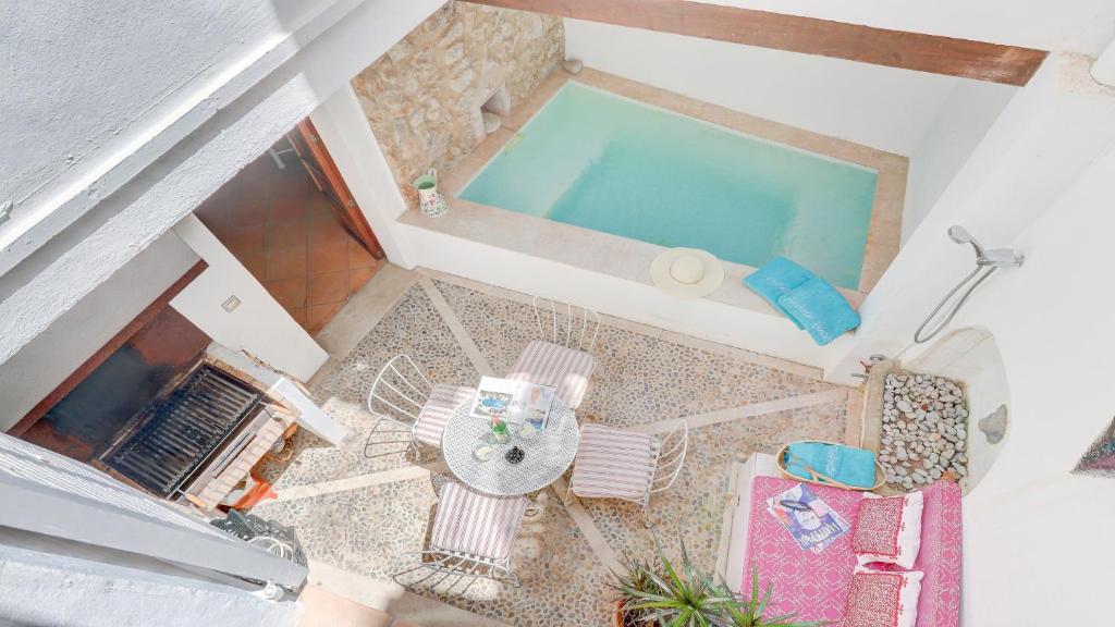 an overhead view of a swimming pool with a table and chairs at Lleo Eleven in Pollença