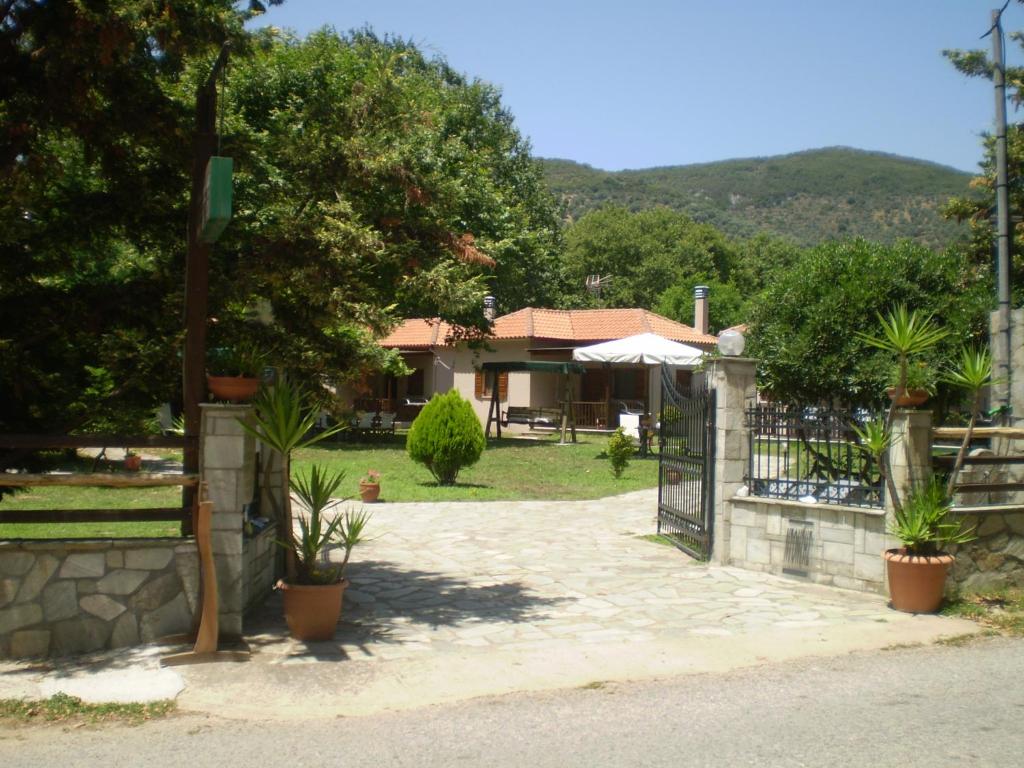 a villa with a gate and a house at Dodis Village in Platanias