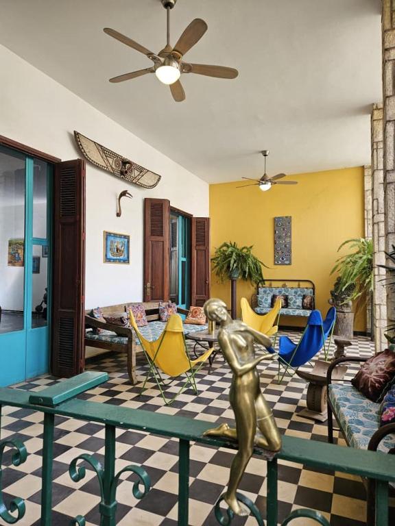 a living room with a statue of a woman on a table at Villa La Drianké in Dakar
