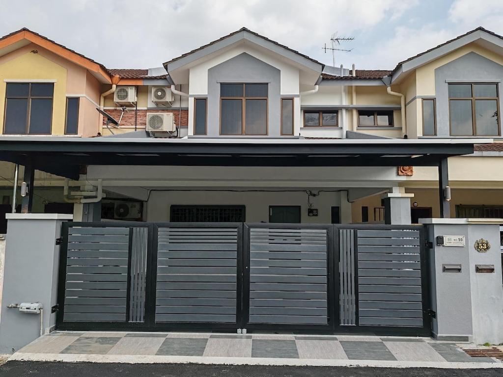 a house with a gate in front of it at ipohbnb Bercham HomeStay in Ipoh