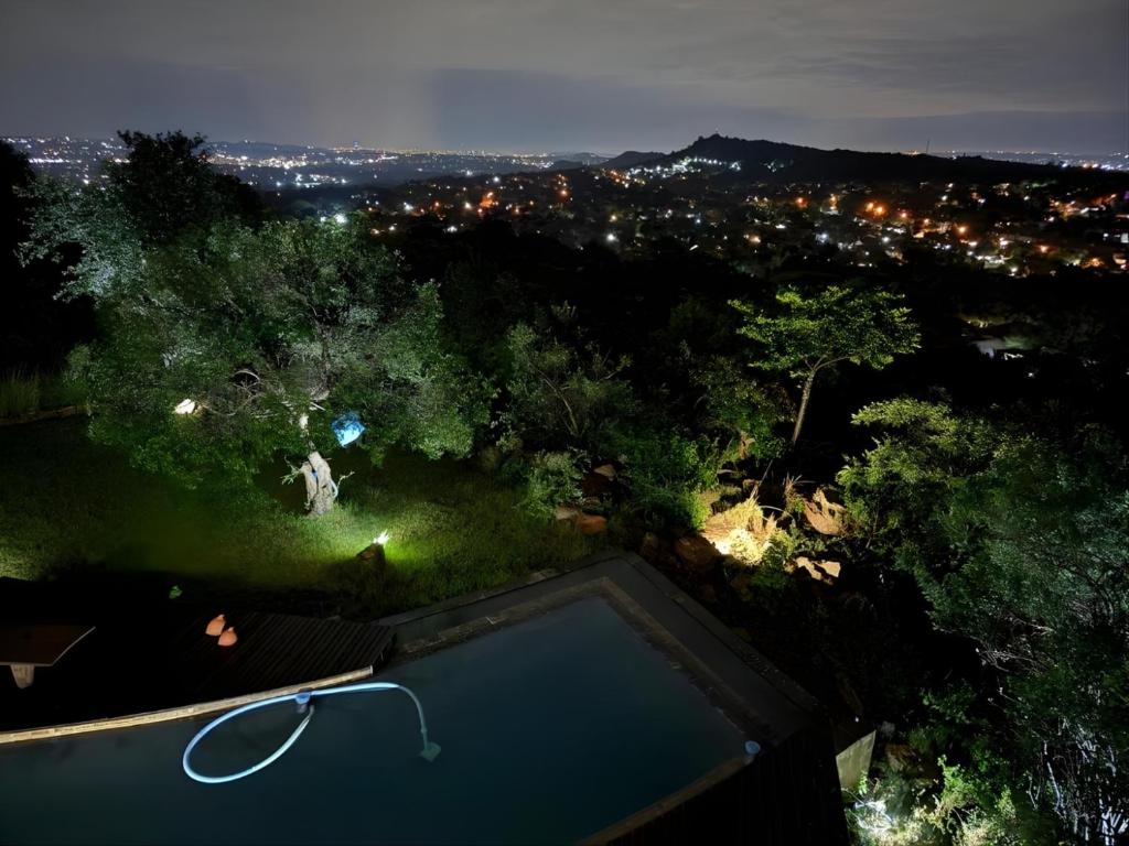 a view of a swimming pool at night at Castle View in Pretoria