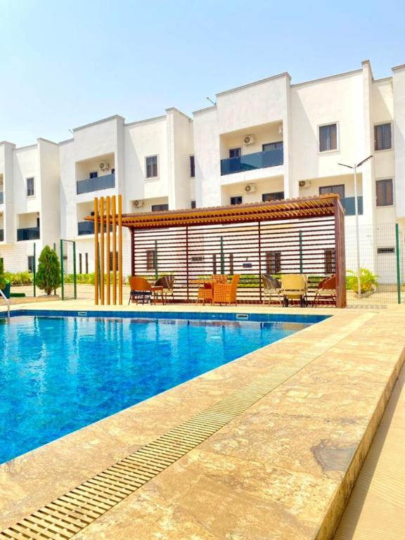 a swimming pool in front of a building at Residence 541 Apartments and Suites in Abuja