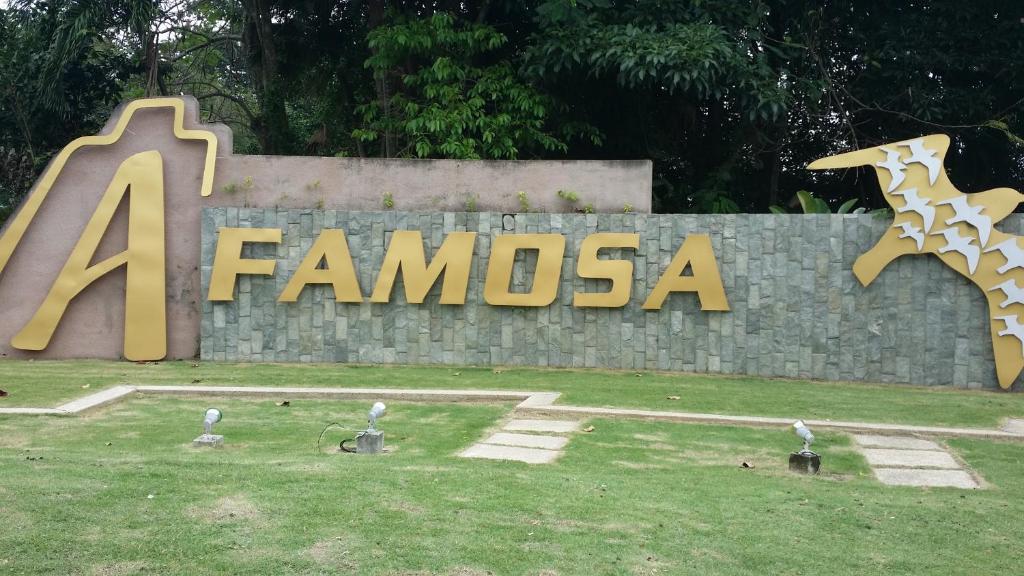 a sign for a zoo with a giraffe on it at A Famosa Resort Melaka in Melaka