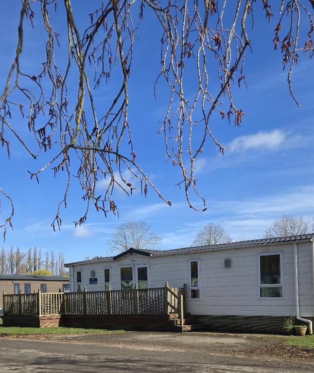 a large white building with a fence at Parkview Billing Aquadrome in Great Billing
