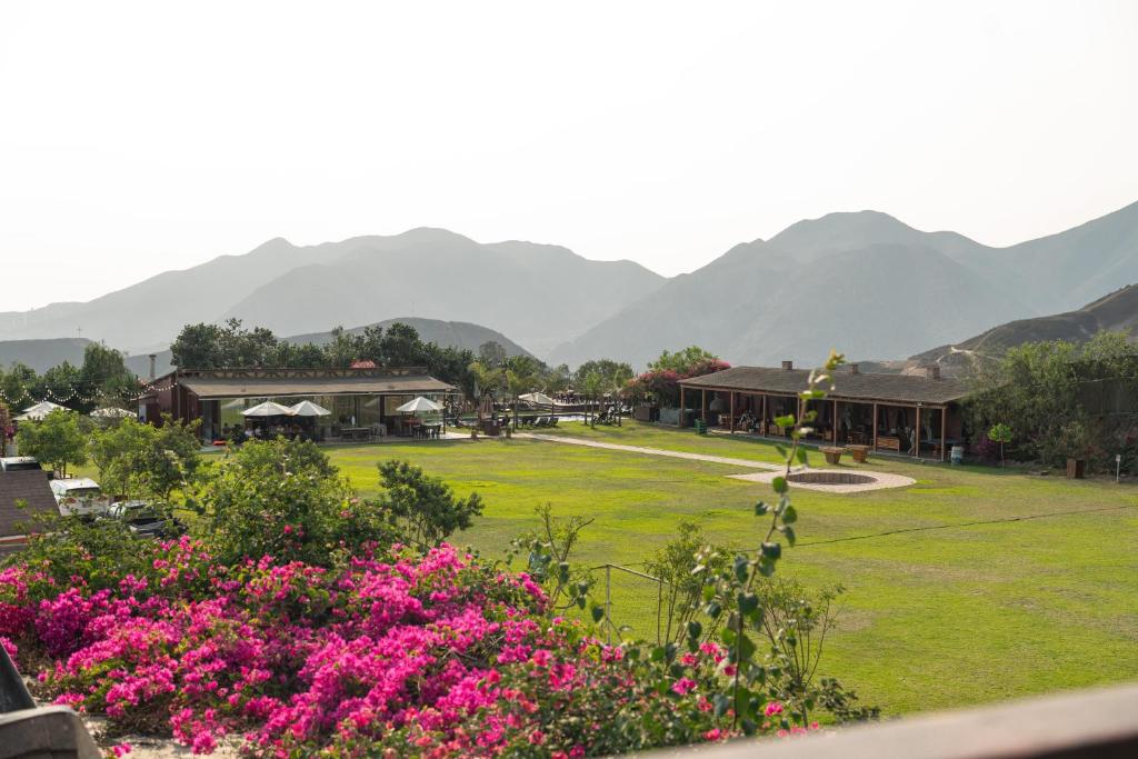 a view of a park with mountains in the background at Ranch Pachacamac in Pachacamac