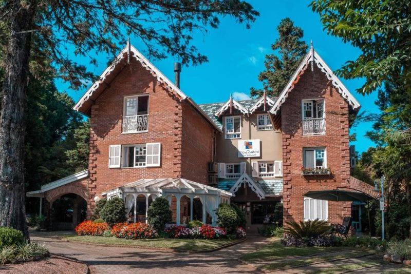 a large red brick house with a tree at La vanguardia by Don Ramon Hotel Boutique & Spa in Canela
