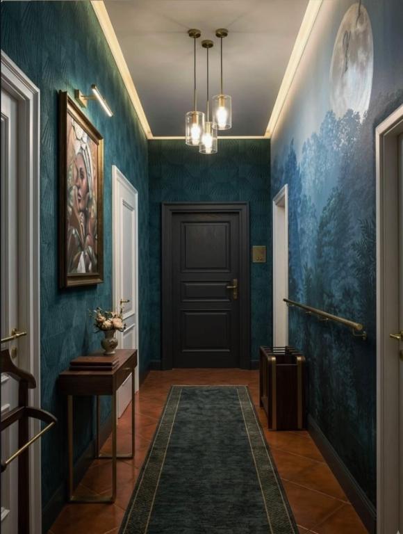a hallway with blue walls and a black door at Amazon Hostel Center Podgorica in Podgorica