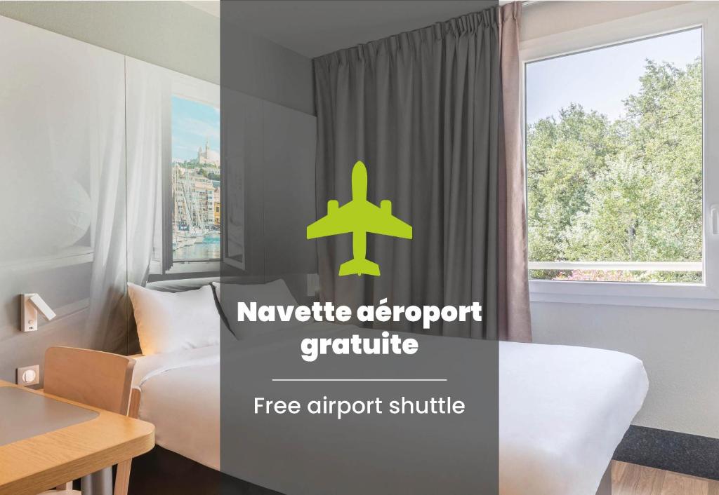 a hotel room with a bed and a window at B&B HOTEL Marseille Aéroport Saint-Victoret in Saint-Victoret