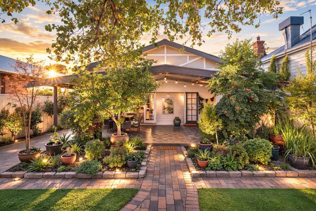 a home with a courtyard with plants and lights at Cozy Cottage with Full Kitchen, Backyard & Patio in Tamworth
