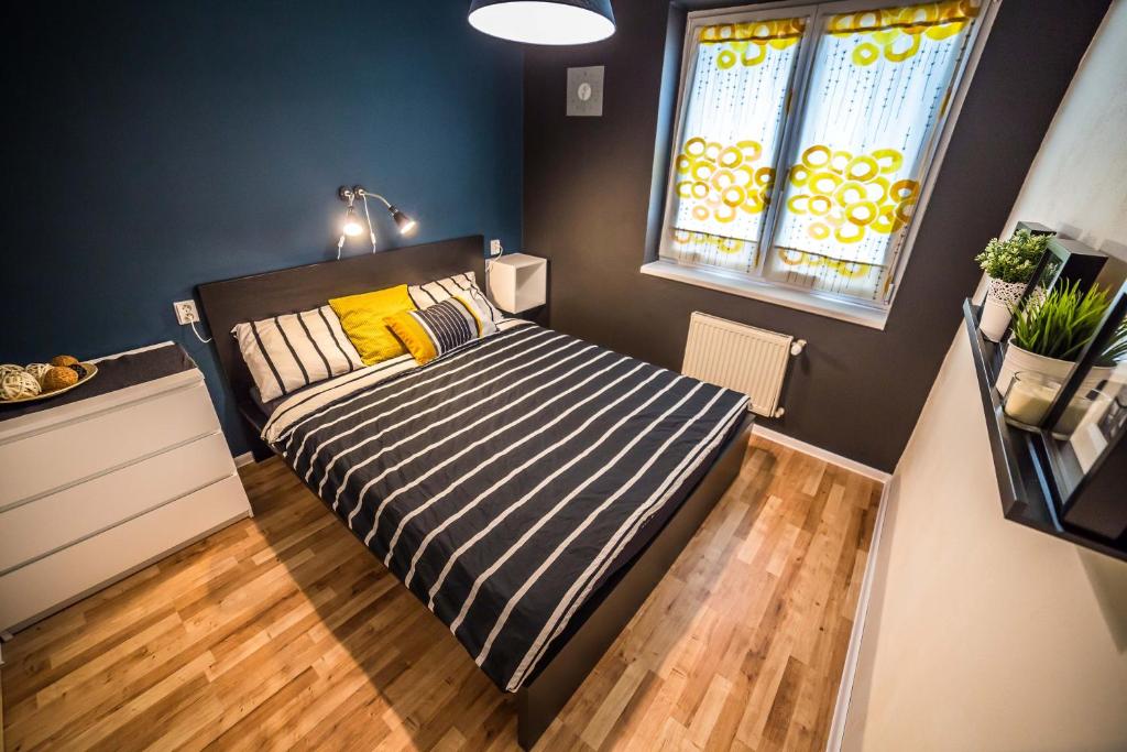 a small bedroom with a bed and a window at Nitra Glycerin Hostel in Nitra