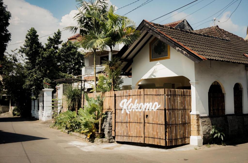 a house with a wooden fence in front of it at Kokomo Yogyakarta in Yogyakarta
